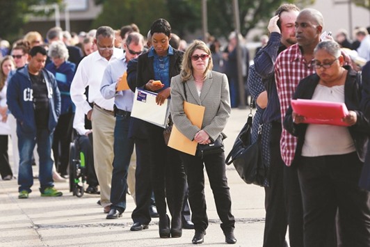 People wait in line to enter the Nassau County Mega Job Fair in Uniondale, New York. Jobless claims in the US rose by 3,000 to 254,000 in the week ended September 24 from a five-month low in the previous period, a Labour Department report showed yesterday.