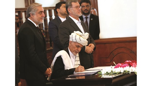 Afghan President Ashraf Ghani, signs a peace agreement with Hizb-i-Islami, led by Gulbuddin Hekmatyar, in Kabul, Afghanistan, yesterday.