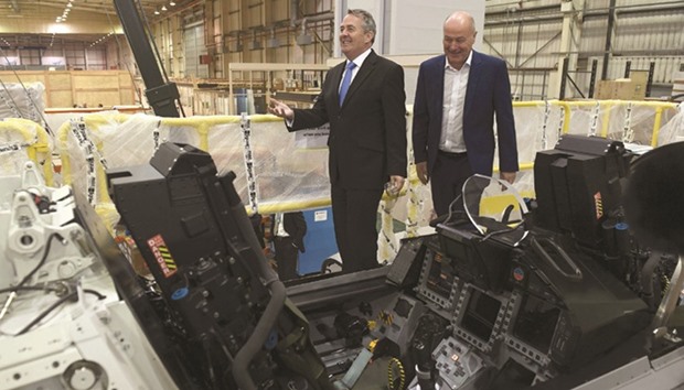 Managing director Tony Birmingham (right) shows International Trade Secretary Liam Fox a Euro Fighter simulator during the latteru2019s visit to training simulator manufacturer, EDM Ltd in Manchester, yesterday. Fox said that trade with the European Union after Britain leaves should be u201cat least as freeu201d as it is now.
