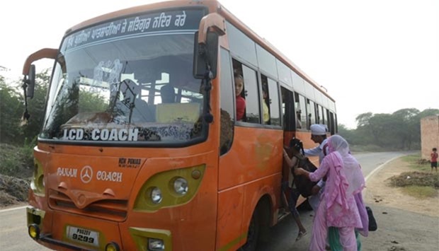 Indian villagers board a bus as they evacuate from the border village of Neshta, about 35 kms from Amritsar, on Thursday.