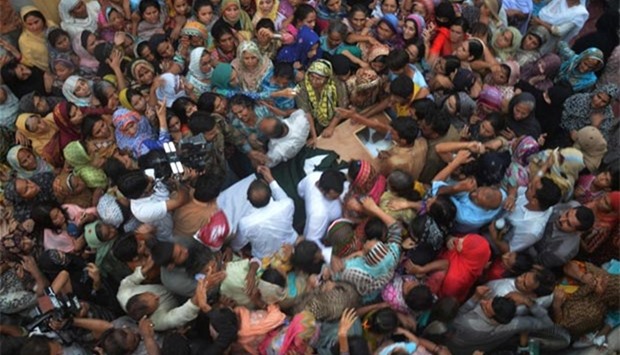 People gather around the coffin of a Pakistani soldier, killed along the Pakistan-India border in Kashmir, during his funeral in Faisalabad on Thursday.