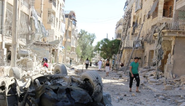 People inspect the damage at a site hit overnight by an air strike in the rebel-held area of Seif al-Dawla neighbourhood of Aleppo, Syria, September 30, 2016