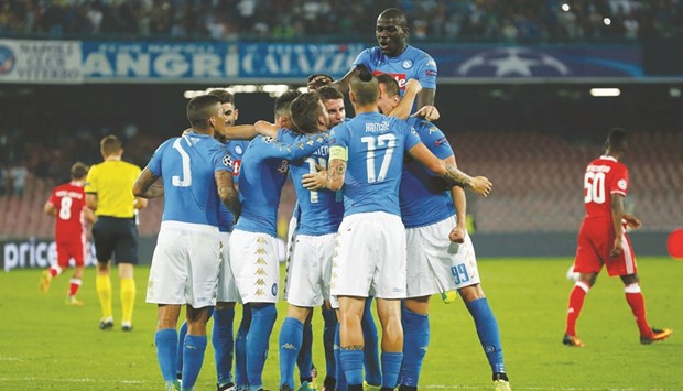 Napoli players celebrate after scoring against Benfica.