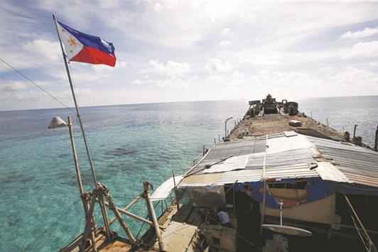 File photo shows a Philippine flag fluttering from BRP Sierra Madre, a dilapidated  Navy ship that has been aground since 1999 and became a Philippine military detachment on the disputed Second Thomas Shoal, part of the Spratly Islands, in the South China Sea.