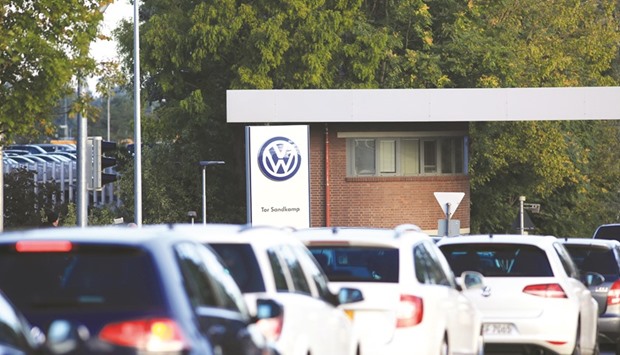 Volkswagen automobiles queue to enter its headquarters in Wolfsburg, Germany. The US Justice Department is assessing how big a criminal fine it can extract from Volkswagen over emissions-cheating without putting the German carmaker out of business.
