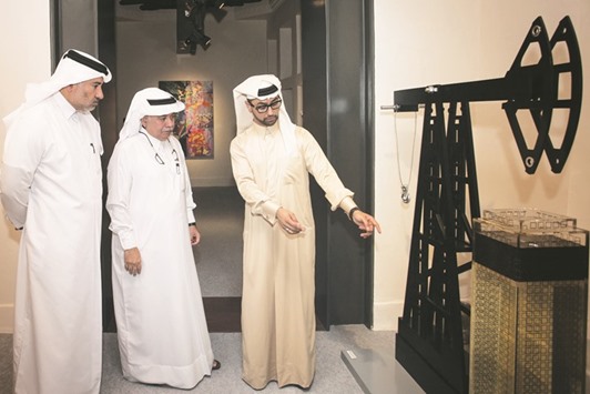 Al-Mehshadi (left) and Qatari artist Ahmed (centre) tour the exhibition.