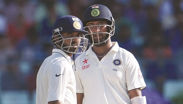 Indiau2019s Ajinkya Rahane (left) and Cheteshwar Pujara scored half centuries on Day One of the second Test against New Zealand at Eden Gardens in Kolkata, India, yesterday. (AFP)