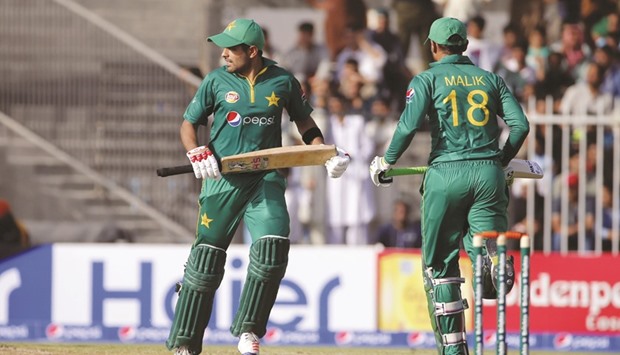 Pakistanu2019s Babar Azam (left) and Shoaib Malik run between the wickets during the first ODI against West Indies at the Sharjah Cricket Stadium yesterday. (AFP)