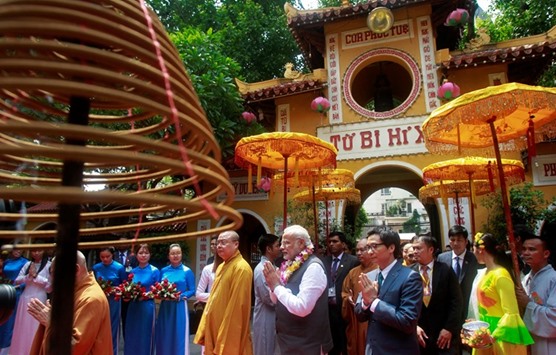 Prime Minister Narendra Modi walks with Vietnamu2019s Deputy Prime Minister Vu Duc Dam (front row, right) and Buddhist monk Thich Thanh Nhieu as he visits Quan Su Buddhism pagoda in Hanoi yesterday.