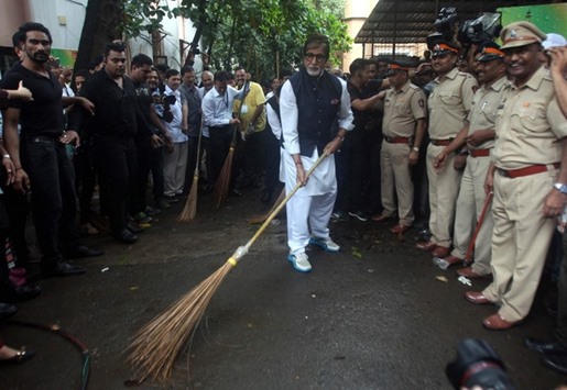Bollywood actor Amitabh Bachchan sweeps a road in front of the J J Hospital complex in Mumbai yesterday.