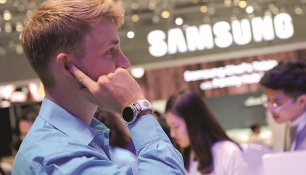 An assistant presents a smart strap that can be used to enable phone conversations by placing the finger to the ear at the IFA Electronics show in Berlin on Friday. At Europeu2019s biggest consumer electronics show, manufacturers including Huawei and ZTE Corp showcased phones aimed at grabbing market share from incumbents Samsung and Apple.