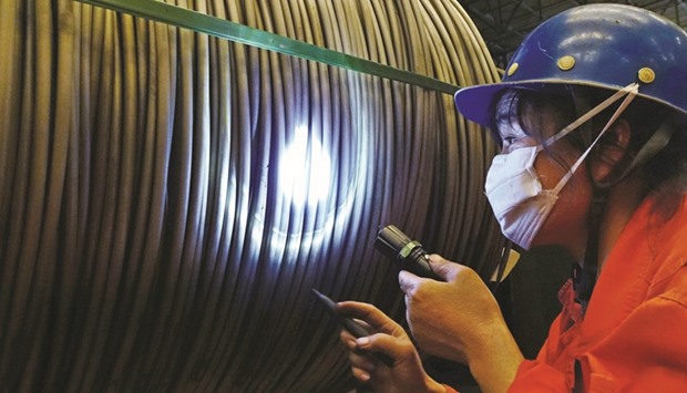 A worker verifies a product at a steel factory in Dalian, Liaoning province. The global flood of Chinese steel is stoking trade tensions with nations from India to Europe, and US lawmakers have asked President Barack Obama to raise the oversupply issue with his hosts at the G-20 meeting in Hangzhou in eastern China.