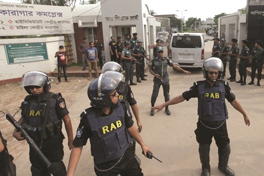 Security personnel stand alert at the entrance to Kashimpur Central Jail on the outskirts of Dhaka yesterday, as relatives of jailed Bangladeshi leader of Jamaat-e-Islam Mir Quasem Ali arrive to visit him.