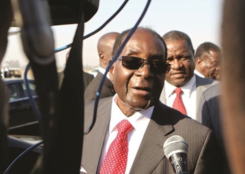 President Robert Mugabe talks to the media at Harare airport yesterday.