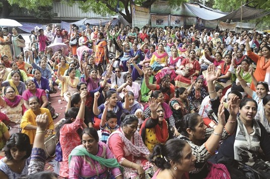 Striking nurses stage a demonstration to press for their demands at Jantar Mantar in New Delhi yesterday.