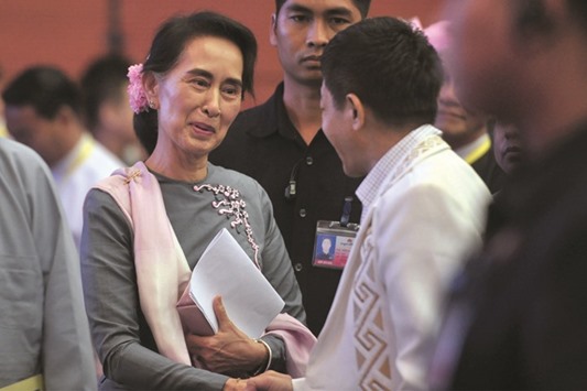Myanmaru2019s State Counsellor and Foreign Minister Aung San Suu Kyi shakes hands with ethnic rebel leader General Gun Maw (right) from the Kachin Independence Army (KIA), the military wing of the Kachin Independence Organisation (KIO), at the conclusion of the peace conference in Naypyidaw yesterday.
