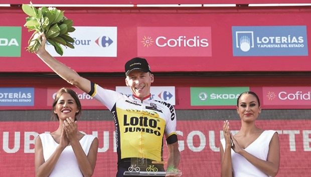 Jumbou2019s Dutch cyclist Robert Gesink celebrates on the podium after winning the 14th stage of the 71st edition of u2018La Vueltau2019 Tour of Spain, a 195.6km route between Urdax to Aubisque, yesterday. (AFP)