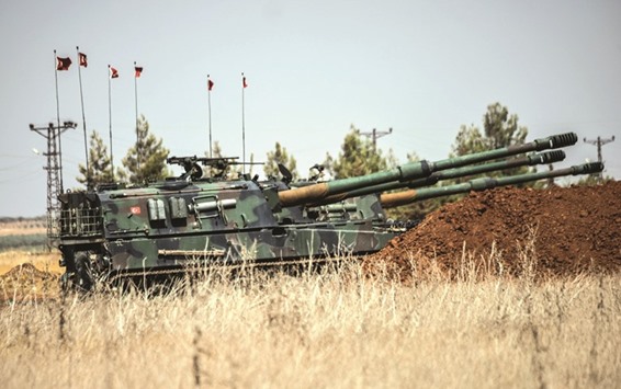 Turkish military tanks are seen during clashes between Turkish soldiers and Islamic State group fighters, 20km west of the Turkish-Syrian border town of Karkamis, in the southern region of Gaziantep, yesterday.