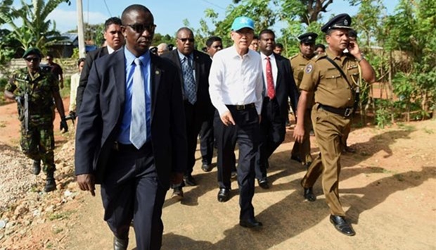 UN Secretary-General Ban Ki-moon walks with officials in the resettlement village of Veeman Kamam on the Jaffna Peninsula on Friday.