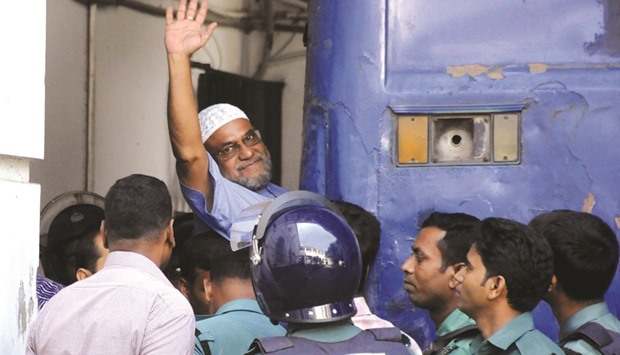 This file photograph shows Jamaat-e-Islami leader, Mir Quasem Ali, waving as he enters a van at the International Crimes Tribunal court in Dhaka.