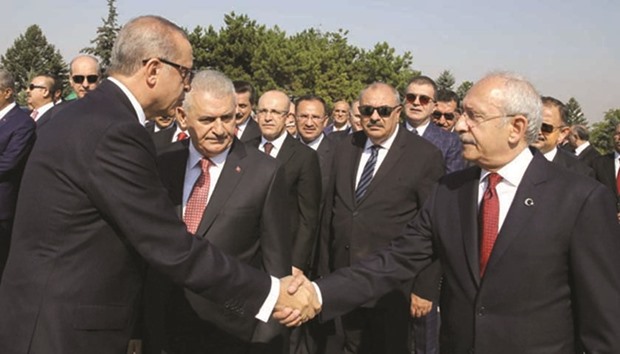 President Tayyip Erdogan shaking hands with main opposition Republican Peopleu2019s Party (CHP) leader Kemal Kilicdaroglu as they are accompanied by Prime Minister Binali Yildirim during a ceremony marking the 94th anniversary of Victory Day at the mausoleum of Mustafa Kemal Ataturk in Ankara on August 30.
