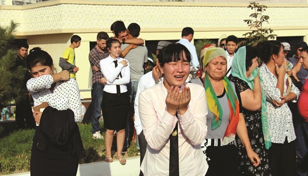 This picture taken on Friday shows people grieving in Tashkent.