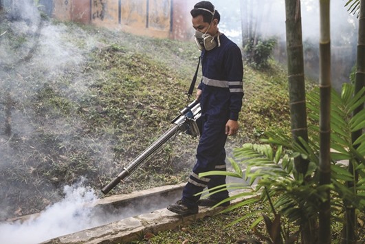A pest control worker fumigates school grounds on the eve of the annual national Primary School Evaluation Test in Kuala Lumpur yesterday.