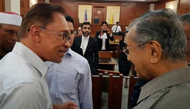 Malaysia's former prime minister Mahathir Mohamad meets with jailed opposition leader Anwar Ibrahim in Kuala Lumpur on Monday.