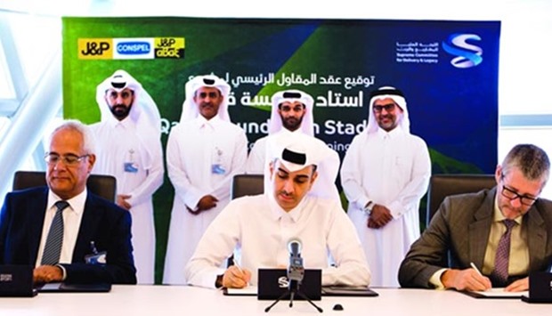 Officials signing the agreement for QF Stadium's main contractor award.