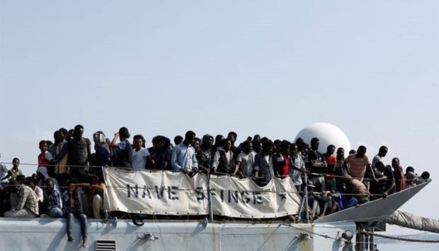 Migrants wait to disembark from the Italian Navy vessel Sfinge in the Sicilian harbour of Pozzallo, southern Italy, August 31, 2016. REUTERS