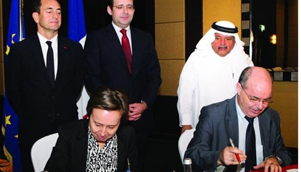 Officials from Alstom Transport and HEC Paris in Qatar sign the agreement while (standing, from left) French ambassador Eric Chevallier, French Minister of State for Foreign Trade Matthias Fekl, and QBA chairman Sheikh Faisal bin Qassim al-Thani look on. PICTURE: Nasar T K