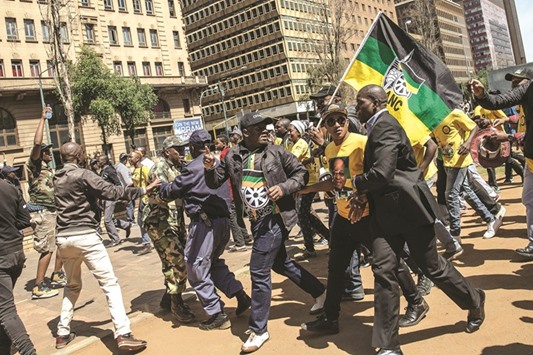 South African ruling party African National Congress president and national executive committee supporters chase disgruntled members demonstrating outside ANC headquarter in Johannesburg, South Africa.