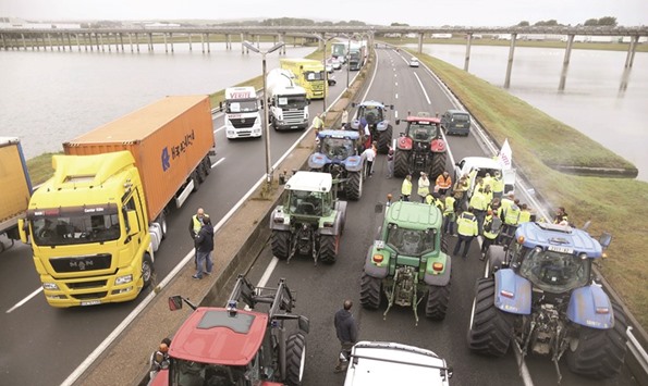 Harbour workers, truck drivers, farmers, storekeepers, and residents block a motorway as part of their protest against the migrant situation in Calais.