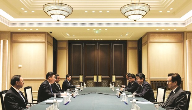 Chinese President Xi Jinping (2nd from left) speaks to Japanese delegation led by Prime Minister Shinzo Abe (2nd from right) during their meeting at the West Lake State House on the sidelines of the G20 Summit, in Hangzhou, Zhejiang province. At the two-day gathering, the worldu2019s most powerful leaders agreed to oppose protectionism, with Xi urging major economies to drive growth through innovation, not just fiscal and monetary measures.