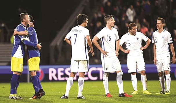 Kosovou2019s (left) players celebrate as Finland players look dejected after a 1-1 draw in the World Cup 2018 qualifying match at Veritas Stadium in Turku, Finland, on Monday. (Reuters)