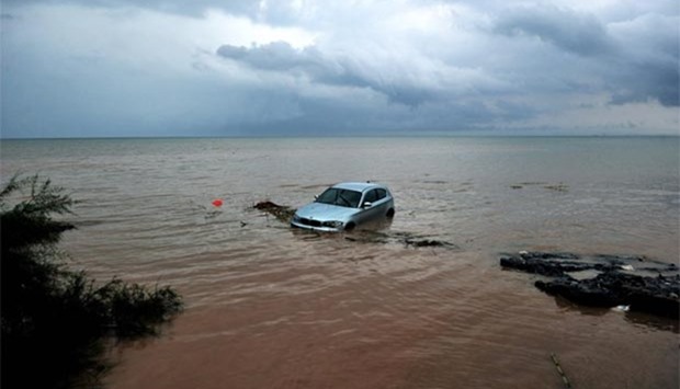 A car washed away into the sea is pictured following floods in Greece. Extensive damage has been reported in the northern city of Thessaloniki.