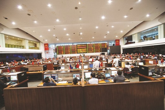 Traders work at the Philippine Stock Exchange in Manila. The key index of the bourse fell 1.3% to 7,619.10 points yesterday in its biggest decline in five weeks.