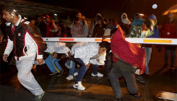 Migrants arrive at the Austrian-Hungarian border station of Nickelsdorf