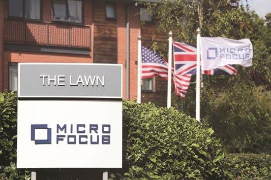 Signs and flags are seen outside the offices of Micro Focus after they and Hewlett Packard Enterprise announced that HPE will spin off and merge its non-core software assets with Britainu2019s Micro Focus International in a deal worth $8.8bn, in Newbury, Britain, yesterday.
