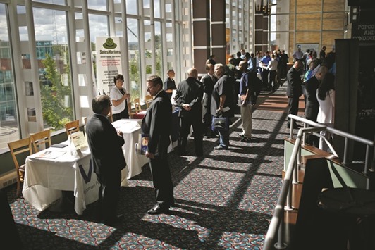 Job seekers speak with recruiters at a military veteransu2019 job fair in Cleveland. Despite signs of underlying labour market strength, Augustu2019s slowdown in job growth, together with sluggish factory and services sector activity could encourage the Federal Reserve to keep interest rates unchanged at its September 20-21 policy meeting.