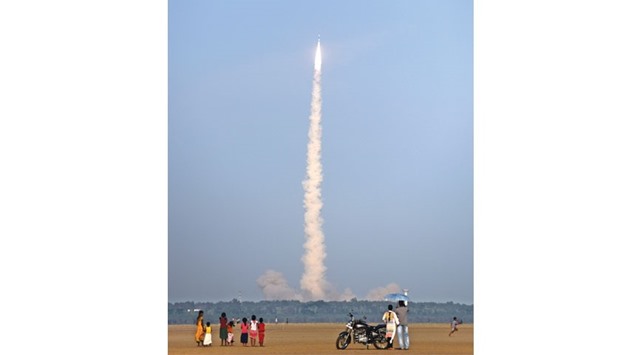 Bystanders look on as the Indian Space Research Organisationu2019s satellite INSAT-3DR, on board the Geosynchronous Satellite Launch Vehicle (GSLV-F05) launches from Sriharikota yesterday.