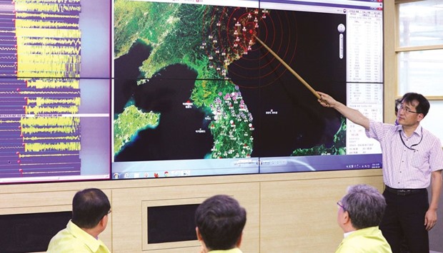 A South Korean official points to a map showing the epicentre of seismic waves in North Korea, at the Korea Meteorological Administration in Seoul, following news of another  nuclear test by North Korea.
