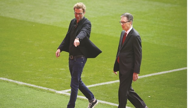 Liverpool manager Juergen Klopp (L) talks with owner John W Henry during the opening of the newly built stand at Anfield.