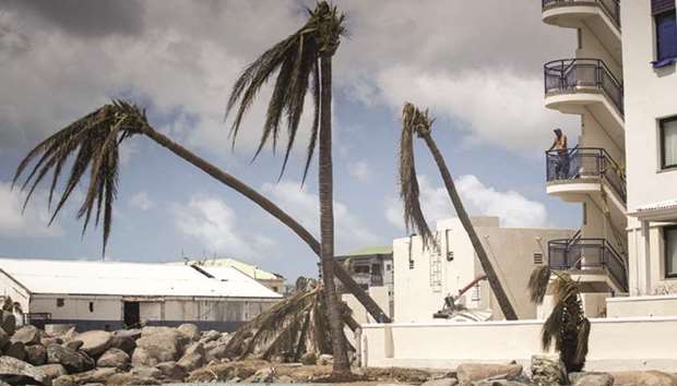 This handout photograph provided by the Dutch department of defence shows a man looking over the devastation of Hurricane Irma in Sint Maarten on Saint Martin island.