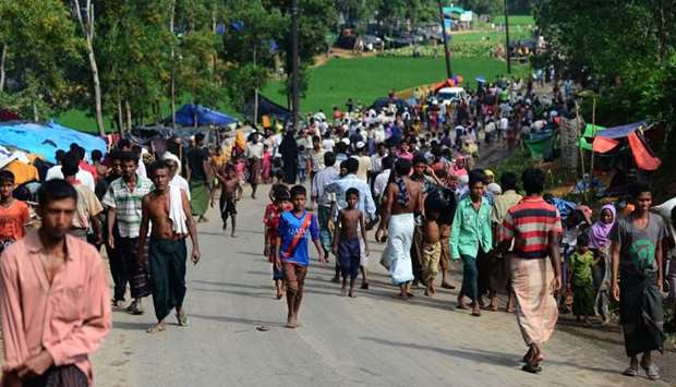 Rohingya refugees arrived from Myanmar walk along the Teknaf-Coxsbazar highway