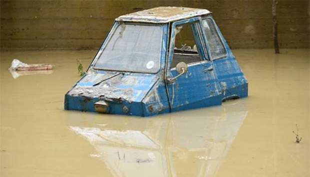 A partially submerged car in the Livorno area is flooded after heavy rain on Sunday.
