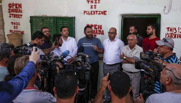 Prominent Palestinian activist Issa Amro speaks to journalists after he was released on bail by a Palestinian court, in the West Bank city of Hebron on September 10, 2017.