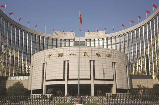 The Peopleu2019s Bank of China headquarters in Beijing. Chinau2019s central bank will effectively remove a reserve requirement for trading foreign currency forwards, a move that may slow the pace of yuan appreciation after its biggest two-week surge in at least a decade.