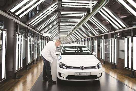 An employee polishes a Volkswagen e-Golf electric automobile in the light tunnel inside the Volkswagen (VW) factory in Dresden, Germany. Two years after u201cdieselgateu201d crashed the last IAA party the organisers are hoping to turn the page this year by focusing on the cleaner cars of the future.