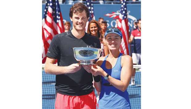 Jamie Murray of Great Britain and Martina Hingis of Switzerland pose after winning the mixed doubles title at the US Open. They defeated Hao-Ching Chan of Taiwan and Michael Venus of New Zealand in the final.